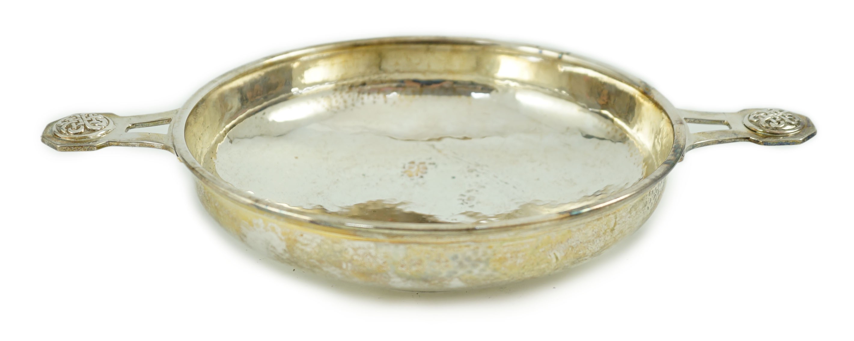 A George V Arts & Crafts planished silver two handled shallow dish, by Albert Edward Jones